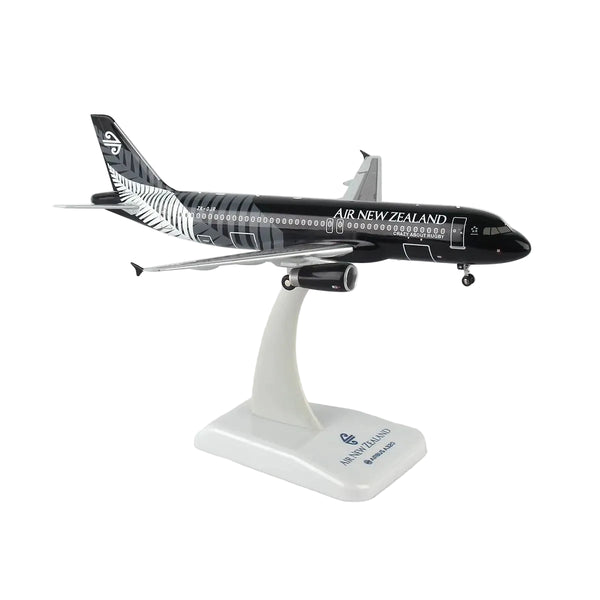 A scale model of an Air New Zealand Airbus A320neo on a white display stand, featuring the airline's black and silver livery.