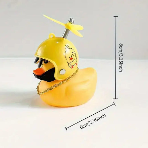 A yellow rubber duck styled like a duck wearing a yellow helmet with a small yellow propeller on top, plus a gold chain necklace. Black text and measurement lines show dimensions of 8cm/3.