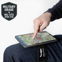 Person using a tablet with a map on a white background, featuring a military-grade certification badge.